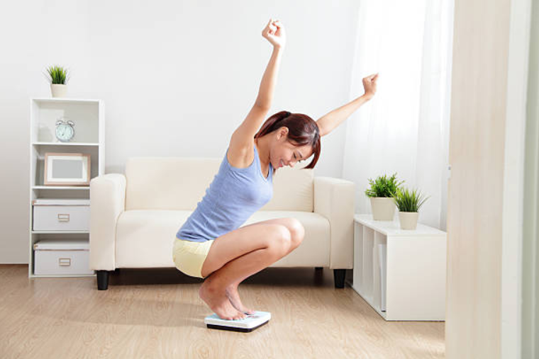 Girl weighing her weight
